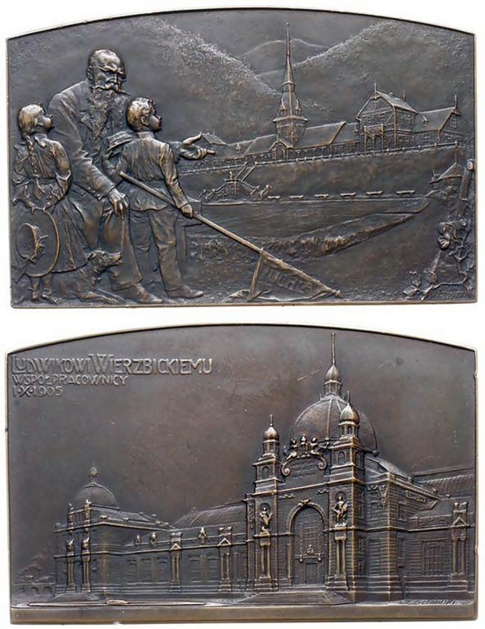 Бронзова плакетка (1905), подарована співробітниками Людвіку Вєжбіцькому. На ній зображено новий двірець у Львові та відпочинкову кольонію для дітей залізничників у Тухлі (хлопчик тримає в руці прапор з написом «Тухля»)